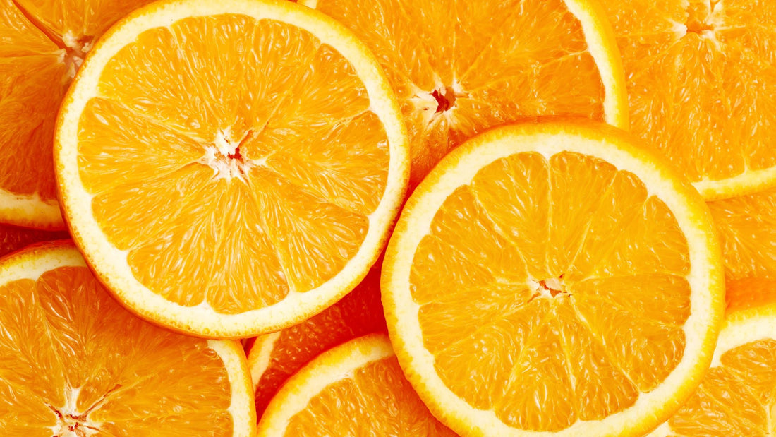 Close-up of fresh orange slices arranged in an overlapping pattern.